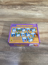 Top view of Lakeshore Calm Down Cubes box showcasing illustrated activity cubes and a hand holding a cube on a wood tabletop