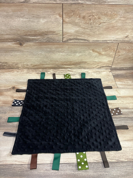 Front view of FOMAISELF black minky dot and camo tag ribbon baby blanket showcasing textured dots and colorful ribbons on wood flooring