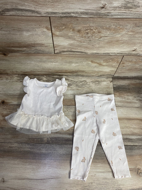 White ribbed baby outfit with ruffle sleeves and tutu top paired with white leggings printed with small beige bunnies