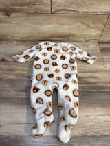 Front view of Little and Loved plush footed blanket sleeper, white fleece with brown lion-face print on wood floor
