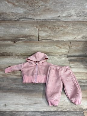 Pink knit baby hoodie and matching pants set laid out on wooden floor, kids resale clothing