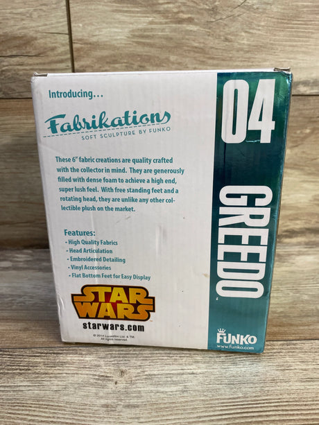 Front of boxed Funko Fabrikations Greedo plush showing packaging with large 04, Star Wars and Fabrikations logos on floor