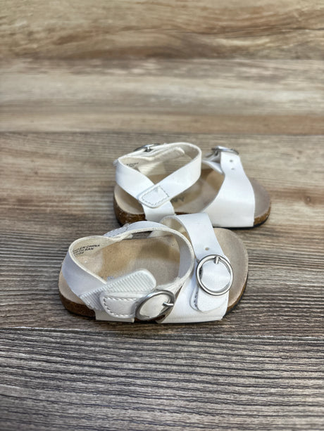 White toddler sandals with buckles on wooden background, kids footwear resale