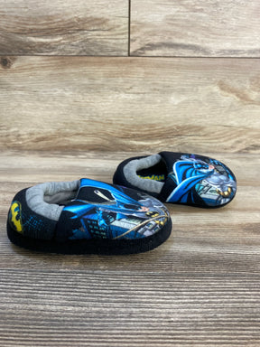 Soft toddler slippers with Batman graphics on a wooden floor