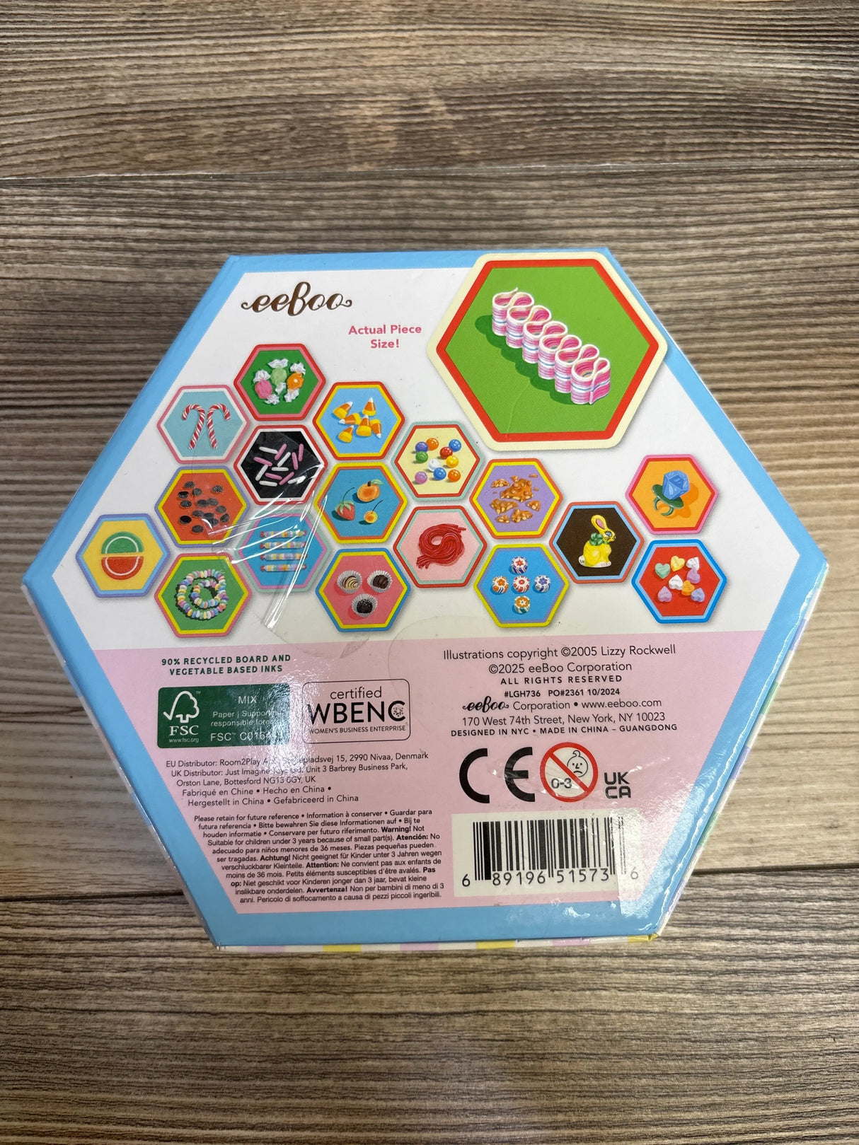Top-down view of eeboo Candy Memory hex box showcasing candy tile art and certification marks on wood background
