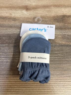Top view of Carter's 3-pack mittens 0-3 months showing navy, light blue and white mittens with '3-pack mittens' band on wood