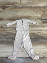 Top-down view of Lou Lou Cove ribbed 2pc newborn set in beige with front buttons and vertical rib texture on wood floor
