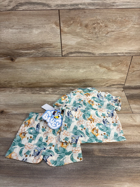 Bluey baby outfit with leaf and character print, soft fabric set on wood floor