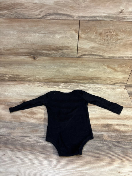Flat lay of Jordan black long-sleeve baby bodysuit (12 months) showcasing long sleeves and snap closure with wood background