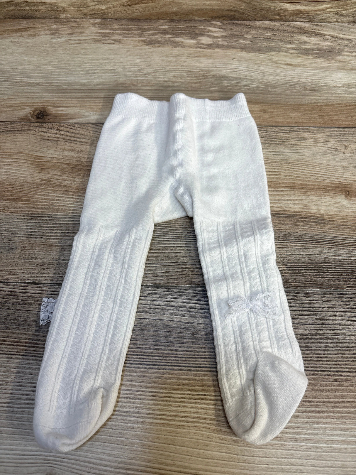 White ribbed baby tights with lace bow, perfect for infants and toddlers