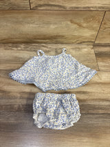 Flat lay of rabbit bear organic tank top and shorts, 0-3M, showing ruffled hem and elastic waist on wood floor
