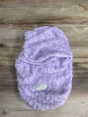 Soft lavender baby swaddle blanket with textured swirl pattern and label on wooden background