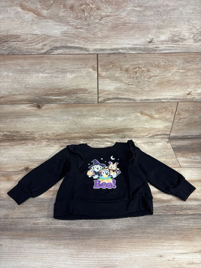 Black kids Halloween sweatshirt with Boo graphic and ruffled sleeves on wood floor