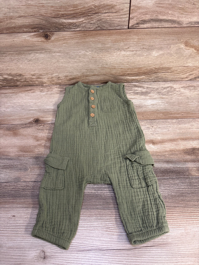 Flat lay of Old Navy olive green sleeveless henley jumpsuit with wooden buttons, chest and cargo pockets on wood floor