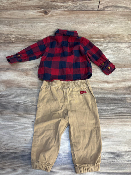 Kids red and navy plaid flannel shirt with tan Wrangler pants on wood floor