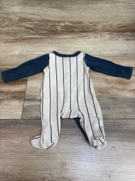 Front view of Carter’s Rookie Snap Sleeper showcasing ivory fabric, navy stripes, long sleeves, and footed legs on wood