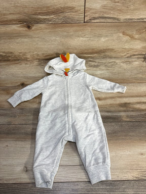 Gray baby onesie with turkey hood, perfect for Thanksgiving, laid on wood floor