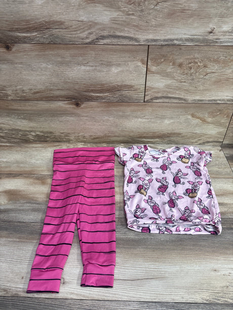 Flat lay of Disney Winnie the Pooh 2pc shirt and pants set showing pink striped pants and character-print shirt on wood