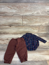 Toddler plaid long sleeve shirt with brown elastic waist pants on wood floor