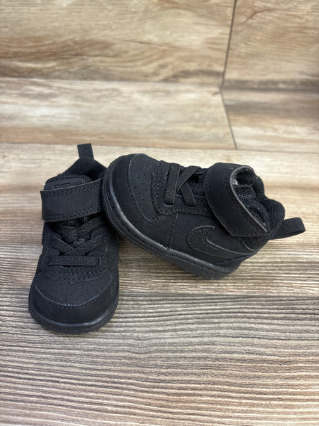 Top view of Nike Court Borough Mid TD Triple Black sneakers showing hook and loop straps on a wood grain floor