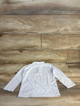 Back view of a white long sleeve kids shirt on a wood background