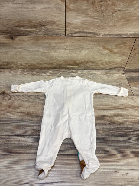 Top view of Old Navy Little Turkey newborn sleeper in ivory with long sleeves and footed legs on a wood floor