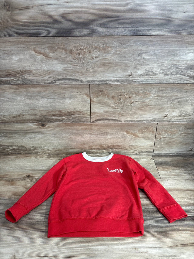 Front view of red Cat & Jack pullover sweatshirt showing white Lovable embroidery and white crew neck on wood background