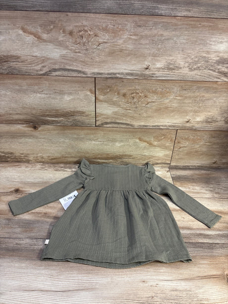 Overhead view of green Burt’s Bees Baby tunic dress with long sleeves, ribbed texture, gathered waist, and ruffled shoulders