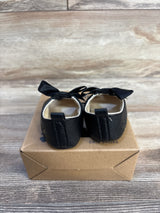 Black baby crib shoes with bows, soft sole, on box