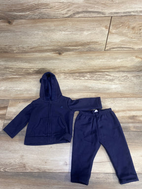 Navy blue toddler hoodie and sweatpants set on wooden floor