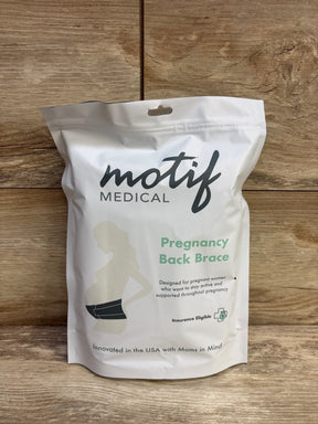 Front view of Motif Medical pregnancy back brace pouch with logo, product name, and belt illustration on wood background