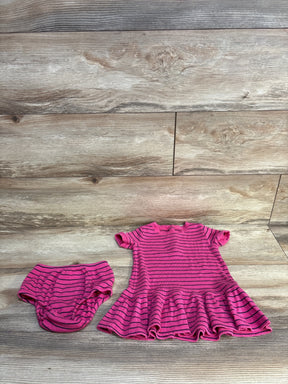 Flat-lay of Ralph Lauren 2-piece pink striped dress with ruffled hem and matching bloomers on wood floor