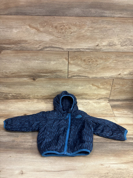 Front view of The North Face Reversible Perrito Hooded Jacket showcasing navy color and front zipper with wood floor