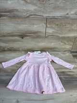 Flat-lay of pink floral long-sleeve toddler dress (18m) with ruffle shoulders and gathered skirt on wood background