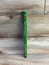 How to Catch a Reindeer children's book with green spine and stocking icon on wood background