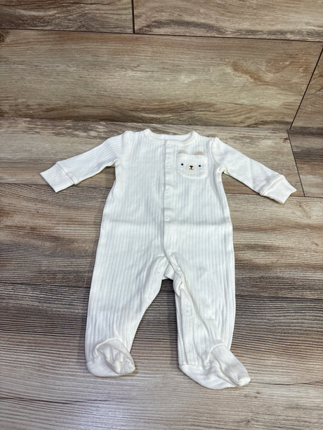 Front view of Starting Out ribbed snap sleeper in ivory, newborn size, with snap front, footed legs, and bear pocket on wood floor