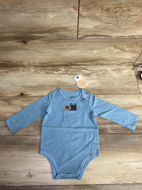 Blue long-sleeve baby onesie with small chest pocket featuring embroidered dog designs