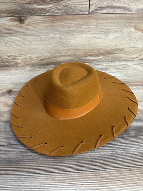 Brown felt cowboy hat with wide brim and leather band on wooden surface