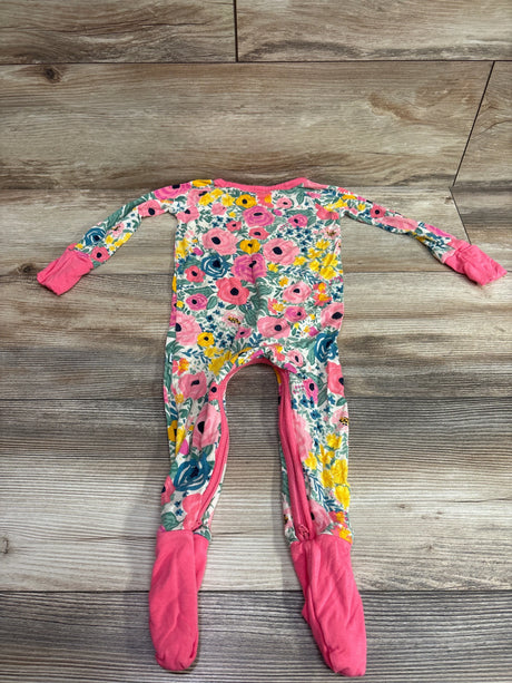Front view of Little Sleepies Floral Bamboo Convertible Sleeper, pink floral print with foldover feet on wood background