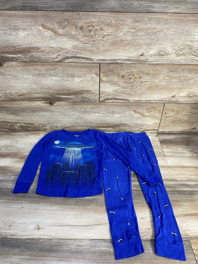 Front view of Carter's 2-piece navy 5T pajama set showing UFO beam and city skyline graphic on top with matching pants on wood floor
