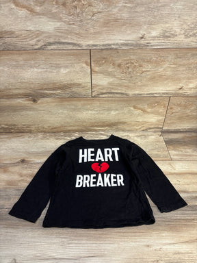 Black long sleeve kids shirt with 'Heart Breaker' and red broken heart graphic on wood floor