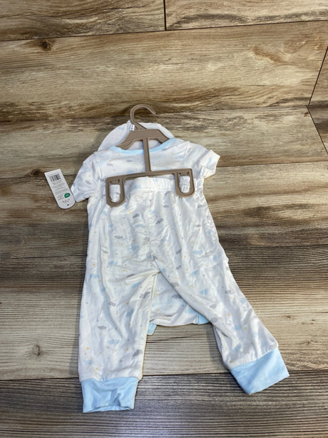 Blue and white baby sleeper with cloud print and footed cuffs displayed on wood floor