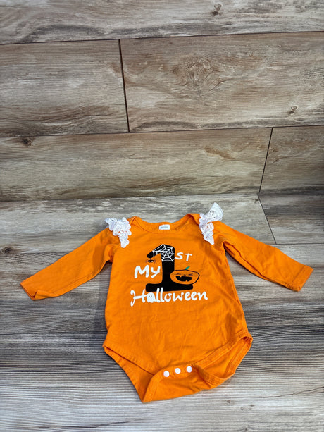 Top-down view of orange long-sleeve baby bodysuit with My 1st Halloween print, lace ruffles and three snaps on wood floor