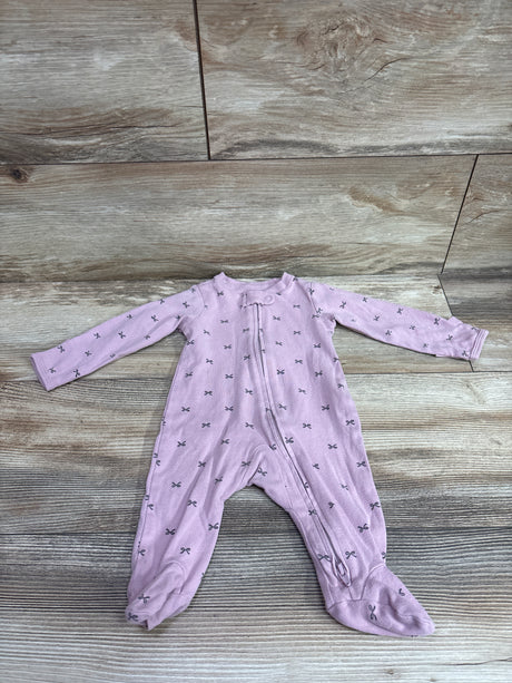 Front view of Carter’s lilac 3-month sleeper showcasing a front zipper, footed legs, and bow pattern on a wood floor
