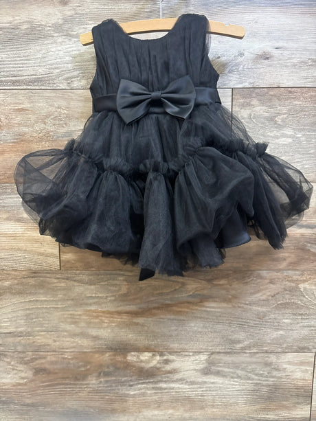 Front view of black sleeveless layered tulle bow dress in size 2T showcasing a large waist bow and tiered tulle skirt on a hanger