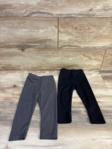 Front view of two black ribbed baby leggings (9-12 months) showing ribbed knit texture on white background