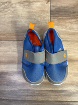 Top-down view of See Kai Run Ryder FlexiRun water shoes showing blue mesh upper, gray Velcro strap, orange heel pull tab on wood floor