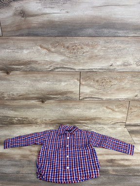 Red, white, and blue plaid long-sleeve toddler shirt on wooden floor background