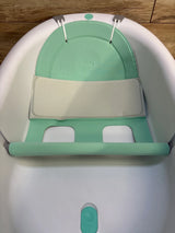 Mint green baby bath seat with cushioned support, perfect for infant bath time safety and comfort.