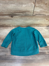 Teal long sleeve toddler sweatshirt displayed on wood background